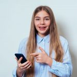 Teen girl excited to read on phone